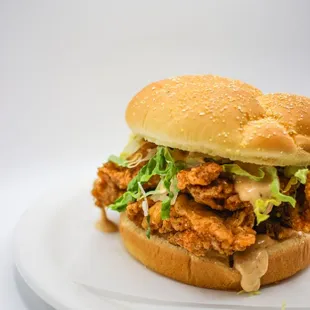 a chicken sandwich on a white plate