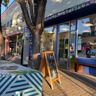 a sidewalk in front of a store