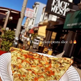 a slice of pizza on a paper plate