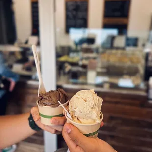 two people holding ice cream cones