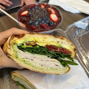 a person holding a sandwich