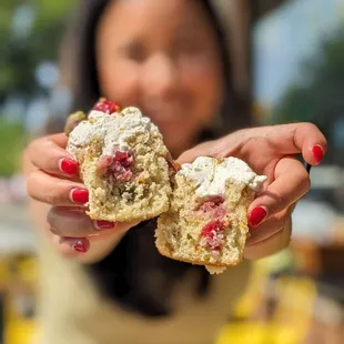 a woman holding a muffin