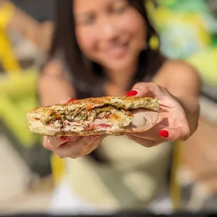 a woman holding a sandwich