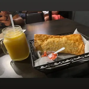 a plate of food and a glass of orange juice