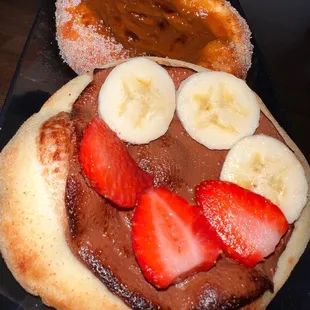 a chocolate sandwich with bananas and strawberries