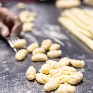 a person cutting dough