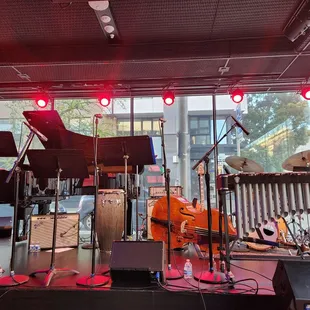 a stage with musical instruments and a piano