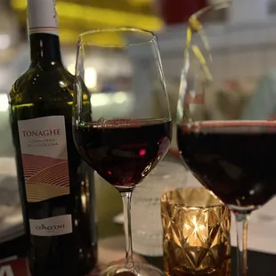 a glass of wine and a bottle of wine