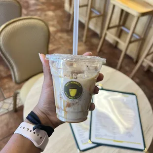 a hand holding a cup of coffee