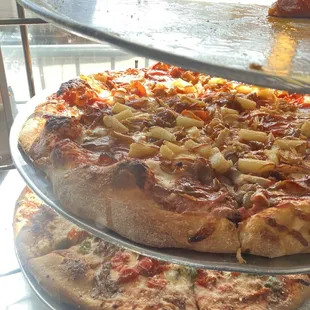 two pizzas on a metal tray