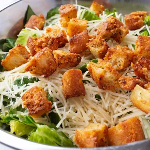 Caesar Salad: Freshly chopped Romaine lettuce topped with our house-made croutons, shredded Parmesan, and a pinch of black pepper....