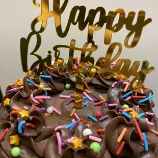 a birthday cake with chocolate frosting and sprinkles