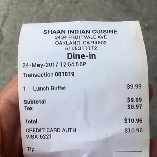 a hand holding a receipt