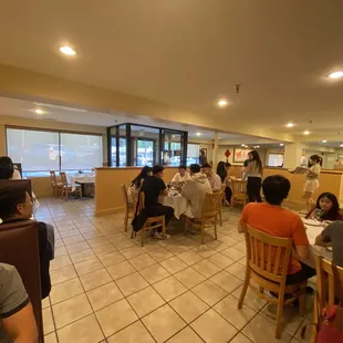 people sitting at tables in a restaurant