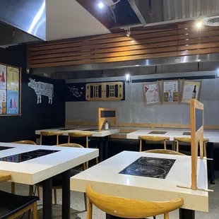 a kitchen area with tables and chairs