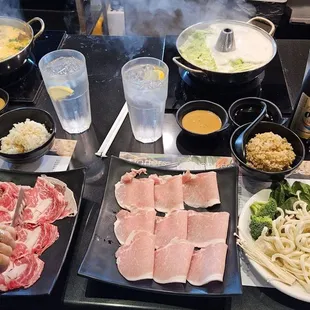 Prime Ribeye (left). Pork (right). Complimentary vegetables and rice. Broth boiling in distance. All great!