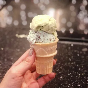 a hand holding an ice cream cone