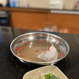 a bowl of soup and a plate of broccoli