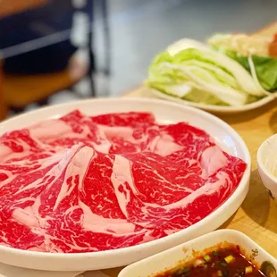 a variety of raw meats on a table