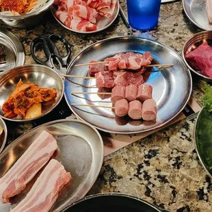 a variety of meats and vegetables on a table