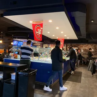 Buffet bar with seafood, veggie and sauces.