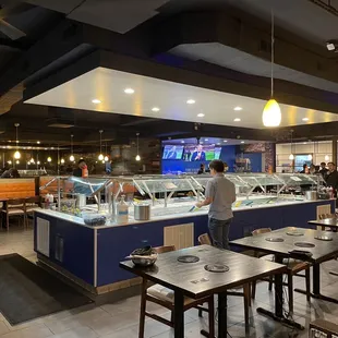 Buffet bar in the center with seafood and veggie options