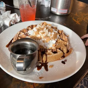 a plate of waffles and syrup