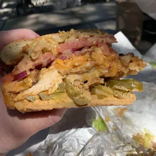 a hand holding a sandwich