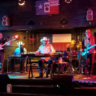 a band playing on stage at night