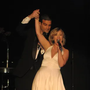 a woman in a white dress and a man in a tuxedo
