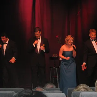 a group of men and women singing