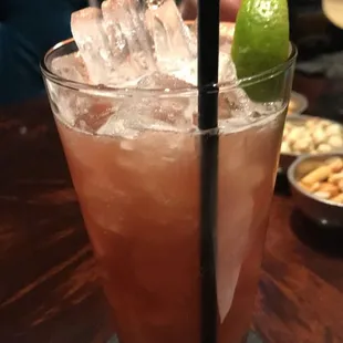a cocktail with ice, lime, and crackers