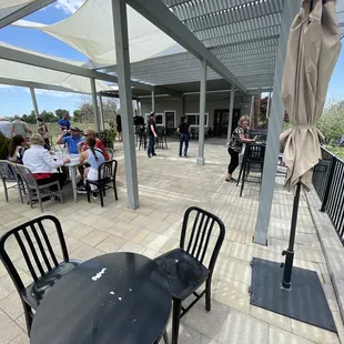 Covered outdoor patio seating area with wood fired pizza oven