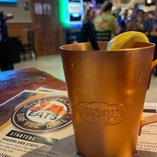 a copper mug with a lemon wedge in it