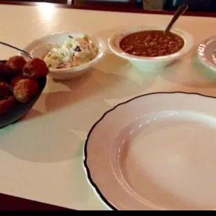 Coleslaw, brown beans, hushpuppies, pickles and onions  come with every meal as well as your sides