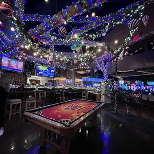 a pool table with christmas lights