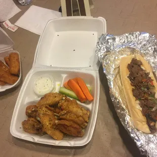 Cheese sticks, wings, and a cheesesteak sandwich
