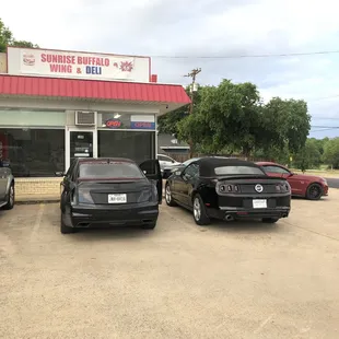 several cars parked in front of a business