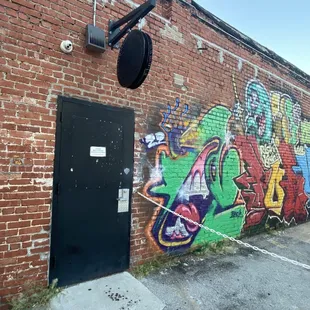 a brick wall with graffiti on it