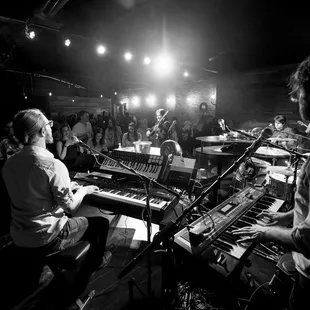 a black and white photo of a man playing a keyboard