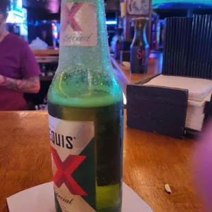 a bottle of beer on a napkin