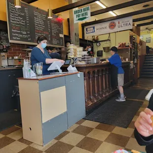 a woman in a face mask at the counter