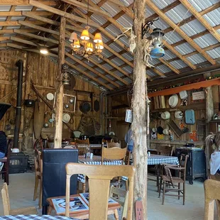 people sitting at tables in a barn