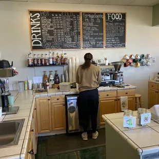 a woman standing in a coffee shop