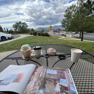 a table with a book and a cup of coffee