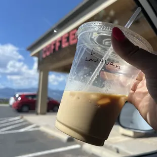a hand holding a cup of coffee