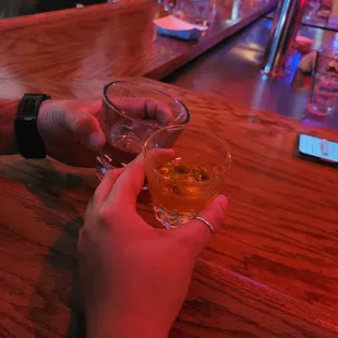 a person holding a glass of alcohol