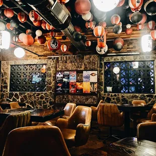 a bar with leather chairs and tables