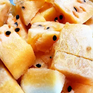 a plate of sliced melon