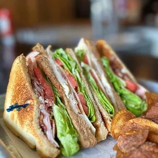 a cut in half sandwich with lettuce and tomato